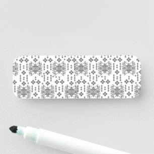 a black and white pattern with a white background name tag