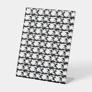 a black and white photo of a pattern pedestal sign