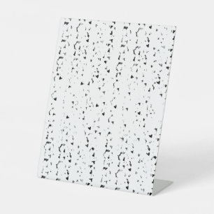 a black and white photo of rain drops pedestal sign