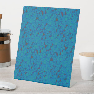 a blue and black background with a pattern pedestal sign
