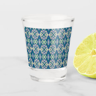 a blue and green pattern with a white background shot glass