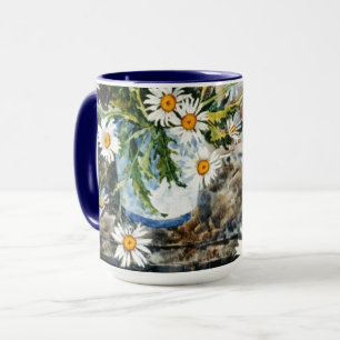 A blue and white pot of wild daisies on a shelf mug