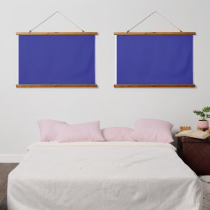 A blue background featuring a prominent white squa hanging tapestry