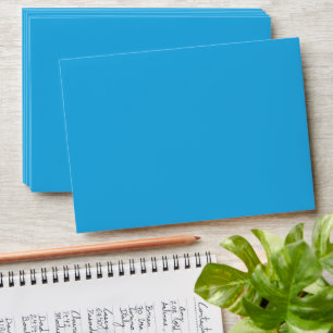 a blue background with a black and white cat envelope