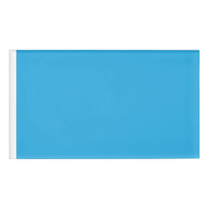 a blue background with a black and white cat name tag