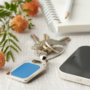 a blue background with a black and white clock keychain