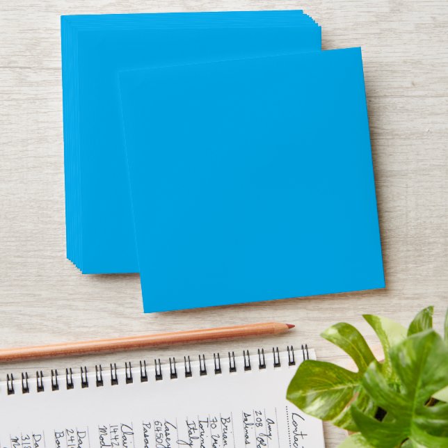 a blue sky with a plane flying in the sky envelope (Stacked)