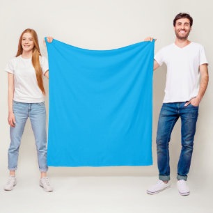 a blue sky with a plane flying in the sky fleece blanket