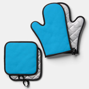 a blue sky with a plane flying in the sky oven mitt & pot holder set