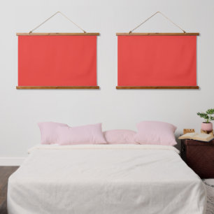 A bold red square surrounded by a crisp white bord hanging tapestry