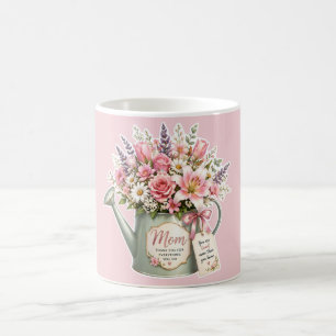 A bouquet of flowers in a watering can for mom coffee mug