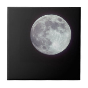 A bright full moon in a black night sky tile