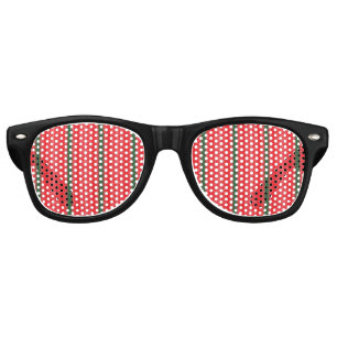 A bright red apple sits on a plain white surface. retro sunglasses