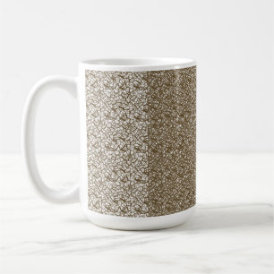 A brown rug with a geometric motif is partially co coffee mug