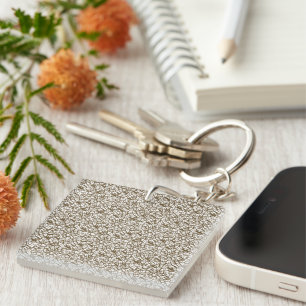 A brown rug with a geometric motif is partially co keychain