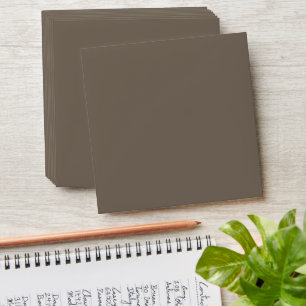 a brown wall with a black and white clock on it envelope