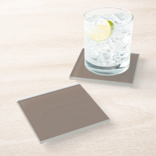 a brown wall with a clock on it glass coaster