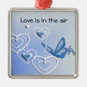 A butterfly and hearts metal ornament