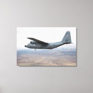 A C-130 Hercules soars through the sky Canvas Print