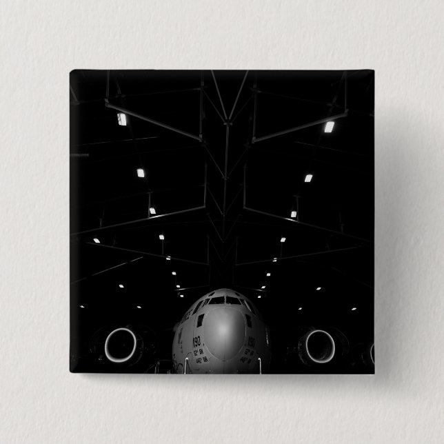 A C-17 Globemaster III sits in a hangar 2 Inch Square Button (Front)