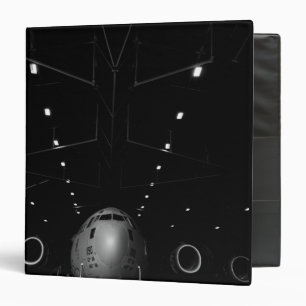 A C-17 Globemaster III sits in a hangar Binder