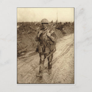 A Canadian Tommy soldier covered in mud returning Postcard