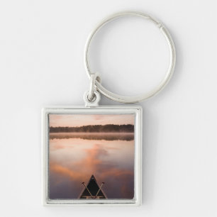 A canoe rests on the shore of Pawtuckaway Lake Keychain