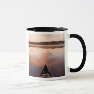 A canoe rests on the shore of Pawtuckaway Lake Mug