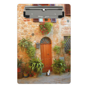 A cat seeks entrance to home in Pienza, Italy Mini Clipboard
