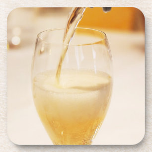 A champagne glass flute being filled with Gosset Coaster