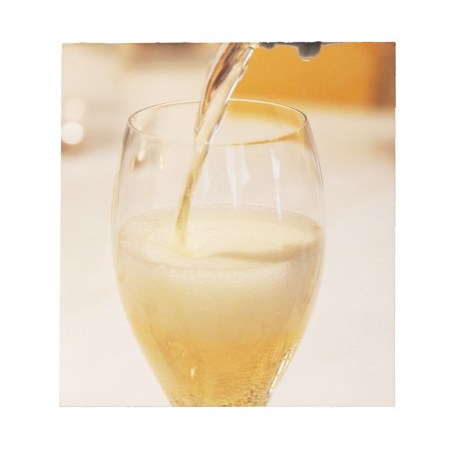 A champagne glass flute being filled with Gosset Notepad (Front)