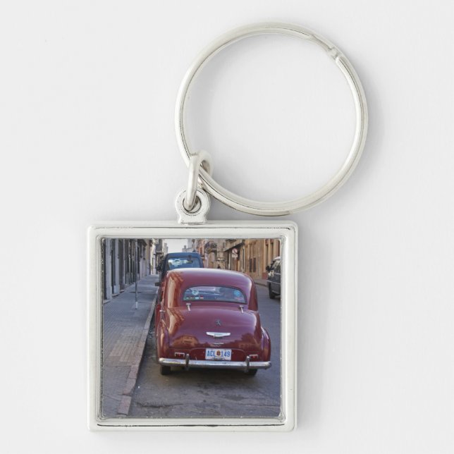 A classic old red Peugeot car parked on a street Keychain (Front)