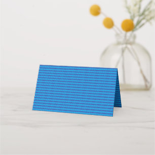 A clear blue sky stretches above a calm, deep blue place card