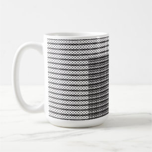 A close-up of a fluffy orange and white cat lying  coffee mug