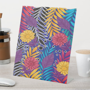a colourful flower and leaves pattern on a blue ba pedestal sign