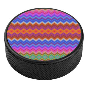 A colourful hockey puck features a vibrant zigzag