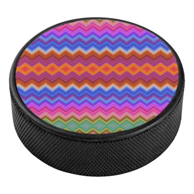A colourful hockey puck features a vibrant zigzag  (3/4)