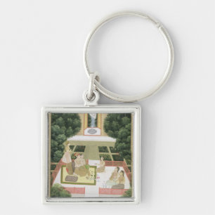 A couple in a garden listening to music with femal keychain