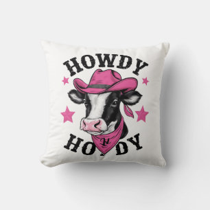 A cow wearing a vibrant pink cowboy throw pillow