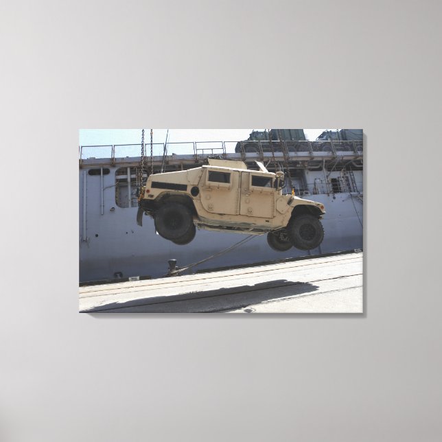 A crane lifts an M998 Humvee Canvas Print (Front)
