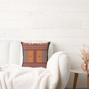 a cross stitch pattern in orange and brown throw pillow