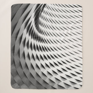 A CURVED FACADE COVERED IN WHITE LATTICEWORK SHERPA BLANKET
