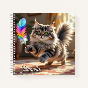 A Cute Fluffy Cat Chasing a Feather Notebook