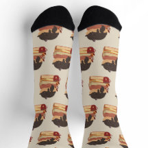 A cute kitten sleeping curled up on a pile of book