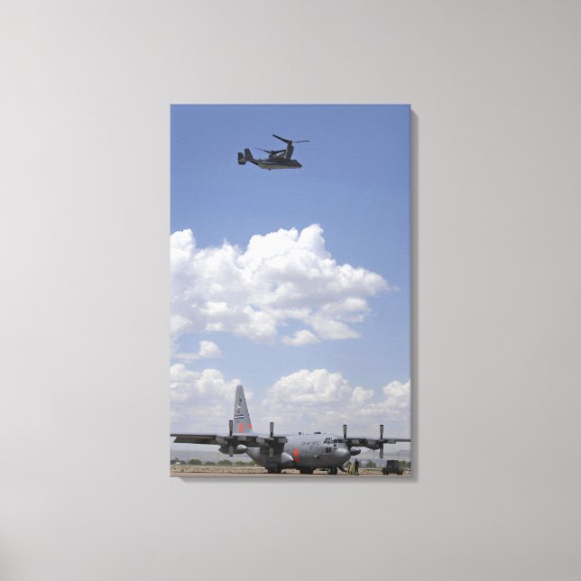 A CV-22 Osprey flies over a C-130 Hercules Canvas Print (Front)