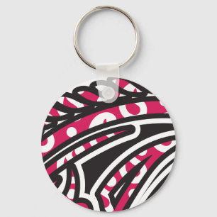 A decorative paisley design with vivid red and pin keychain