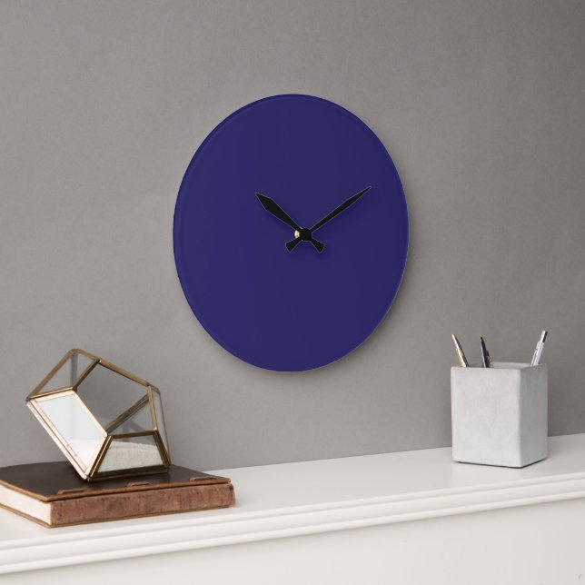 A deep blue backdrop accented by a white border, o large clock (Office)