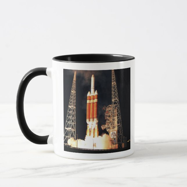 A Delta IV Heavy rocket lifts off Mug (Left)
