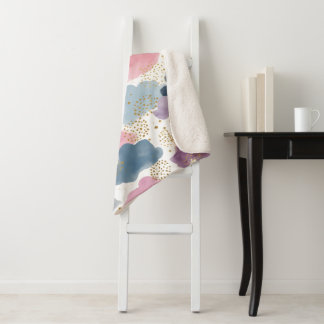 A dreamy watercolor clouds sherpa blanket