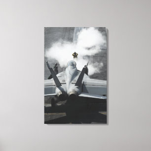 A flight deck director signals an F/A-18F Canvas Print